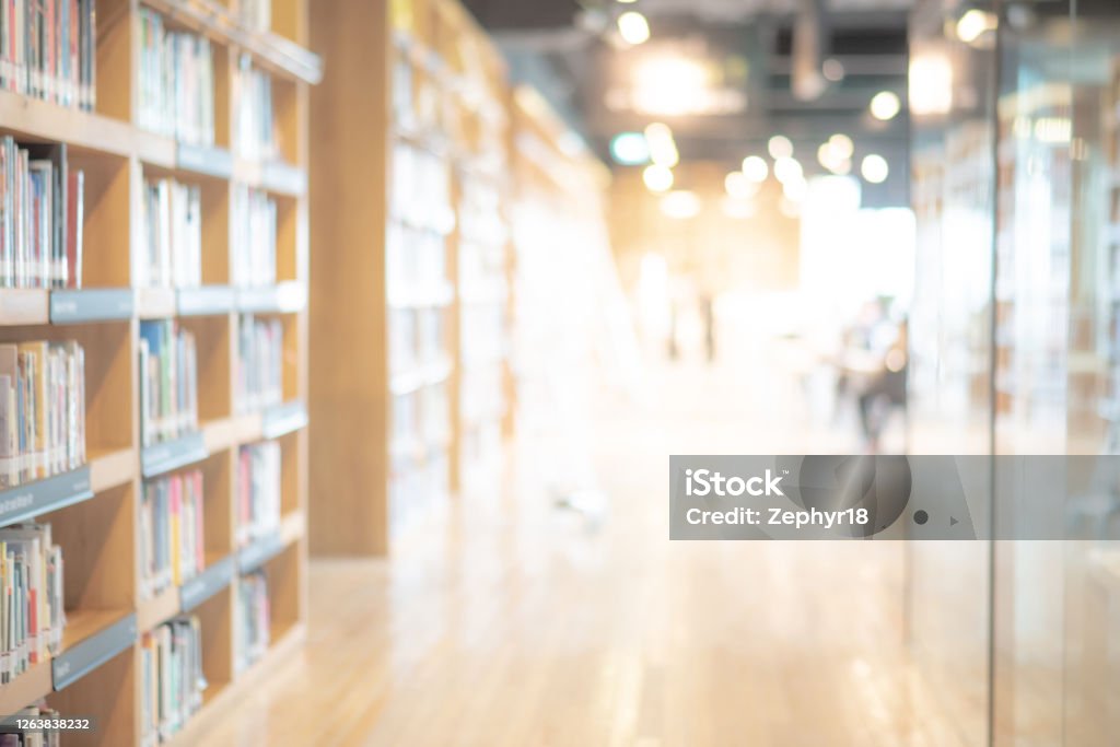 Abstract blurred public library interior background Abstract blurred public library interior space. blurry room with bookshelves by defocused effect. use for background or backdrop in business or education concepts Library Stock Photo