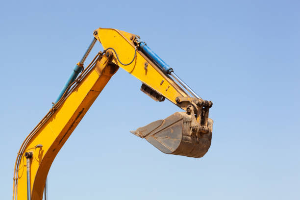 orange crawler excavator during excavation on a blue sky background. loading and transportation of soil. Site preparation