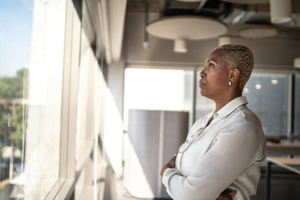 istock Serious businesswoman looking through the window 1263845867