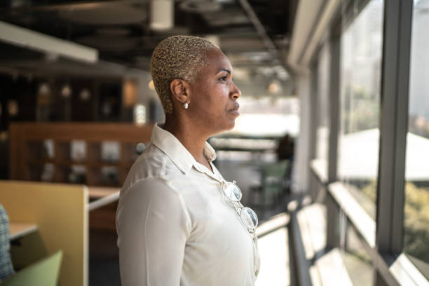 istock Serious businesswoman looking through the window 1263846011