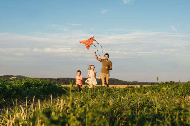 istock Happy family flying a kite 1263847934