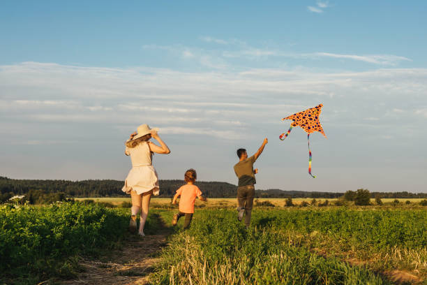 istock Happy family flying a kite 1263847947