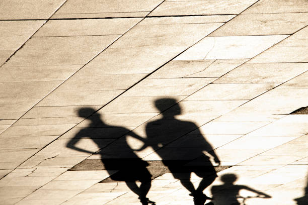 istock Shadow silhouette of young people walking 1263848085