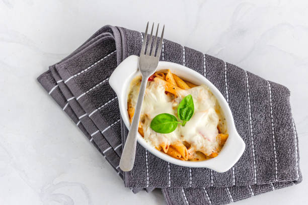 Traditional Italian Baked Pasta with Chicken Garnished with Basil Leaves Directly from Above Horizontal Photo Baked Chicken Pasta with Basil and Cheese Top Down Flat lay Photo chicken rigatoni stock pictures, royalty-free photos & images