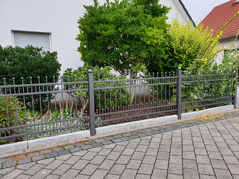 Garden fence made of iron in front of the house