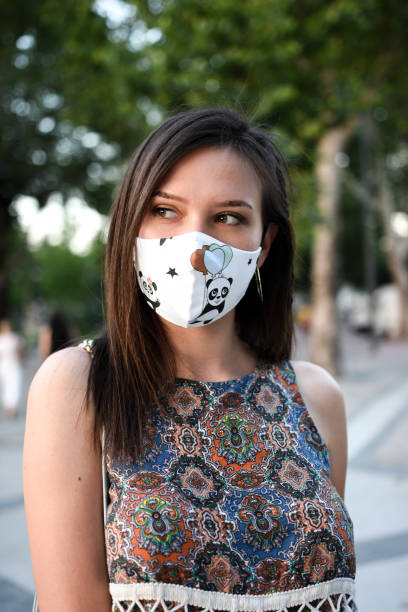 istock Beautiful young woman with protection face mask 1263851950