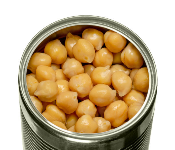 istock Canned chickpeas, large light tan chick peas in an opened tin can 1263852115