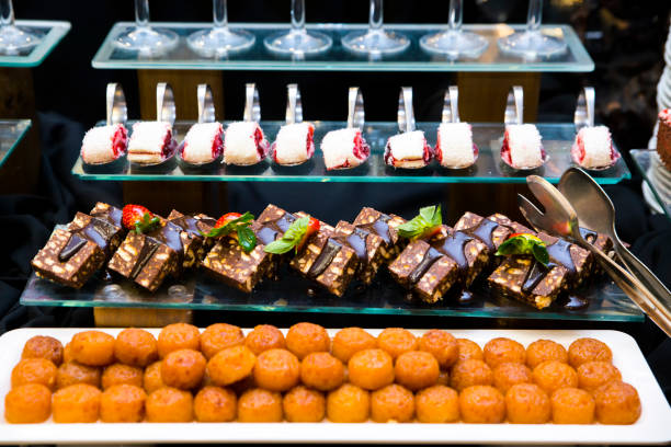 istock Luxury hotel restaurant deserts open buffet. Table with deserts, Sweet desserts and pastries on the table 1263852257