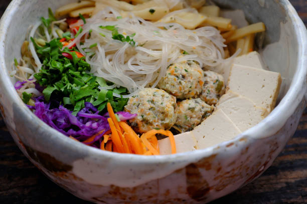 sopa caseira de macarrão vegano vietnamita, legumes coloridos, bolas de tofu, delicioso, nutrição, tigela de prato vegetariano saudável - indochina soup flag national flag - fotografias e filmes do acervo