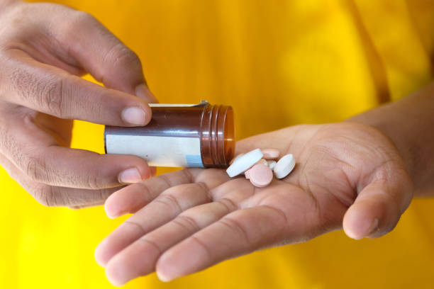 istock Close up of man hand taking medicine 1263853858