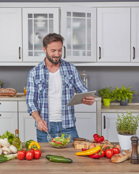 istock Man following the recipe on tablet 1263854891