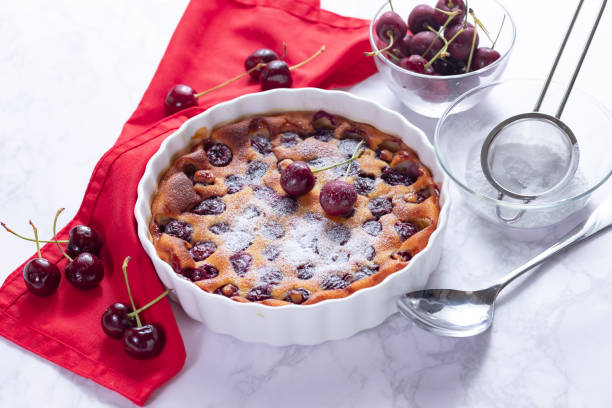 istock Traditional french cherry clafoutis with cherry on white marble 1263857014