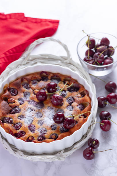 istock Traditional french cherry clafoutis with cherry on white marble 1263857065