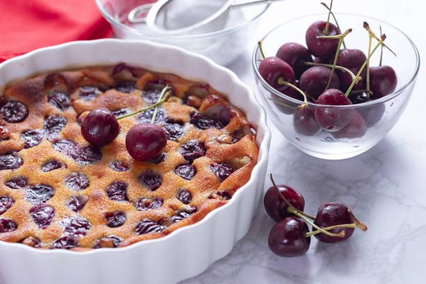 istock Traditional french cherry clafoutis with cherry on white marble 1263857090