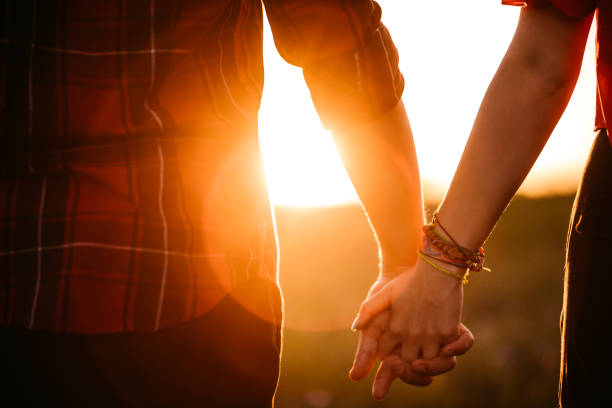 istock Couple holding hands at sunset 1263857251