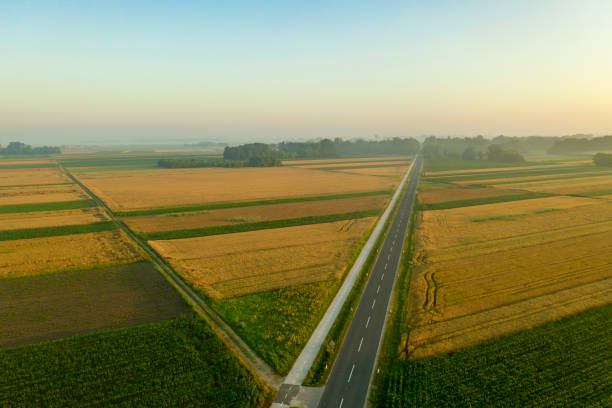 istock Aerial view of road crossing fields 1263857797