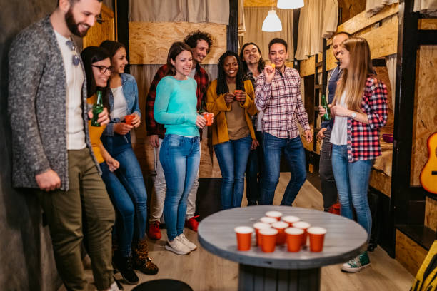 istock Young people playing beer pong in hostel 1263859202