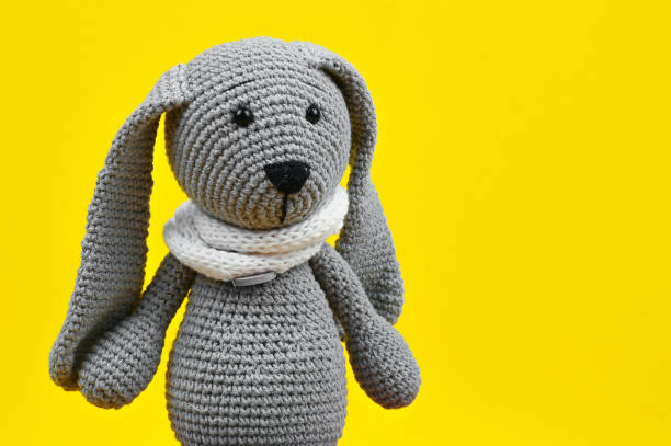 istock gray plush hare on an orange background 1263860695