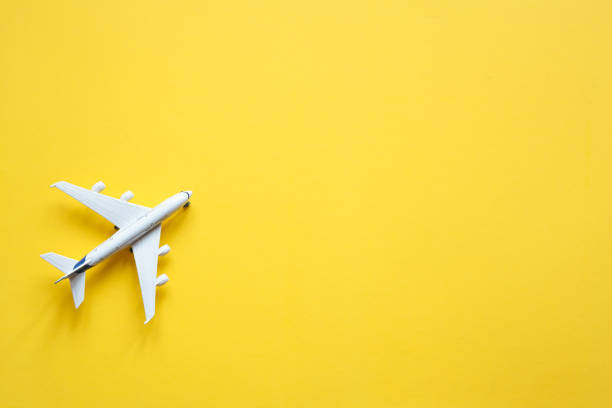 istock Toy plane on a pastel yellow background with top view and copy space. 1263861193
