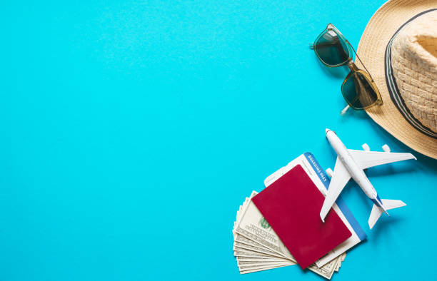 istock Travel accessories with plane fly pass on pastel blue background.  Top  view and copy space Flat lay. Travel background for travel agency banner advertisement. 1263861197