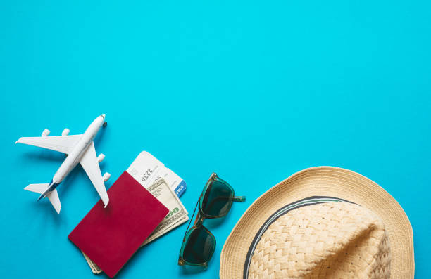 istock Travel accessories with plane fly pass on pastel blue background.  Top  view and copy space Flat lay. Travel background for travel agency banner advertisement. 1263861203