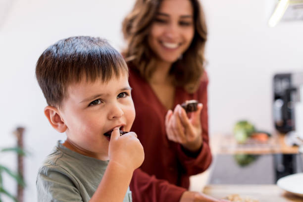 istock Mother and child making chocolate peanut cookies for quarantine 1263861833