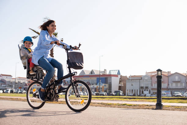 istock Mother riding on a bicycle with young kid 1263861885
