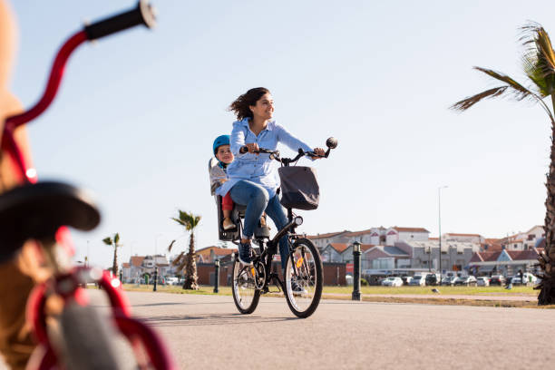 istock Mother riding on a bicycle with young kid 1263861893