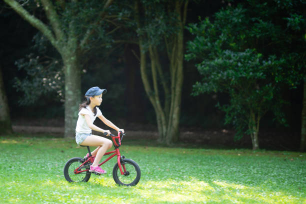 istock Girl riding a red bicycle 1263863409
