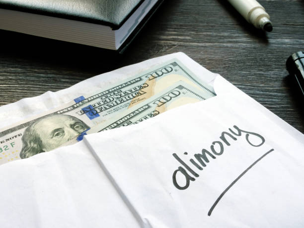 istock Alimony concept. Open envelope with cash on the desk. 1263863925
