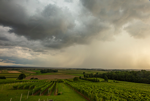 Scenic view of agricultural fields against Storm clouds