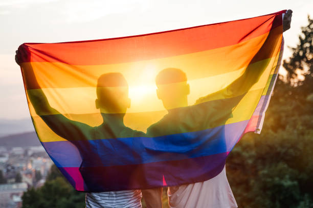 schwules paar - homosexual gay man parade flag stock-fotos und bilder