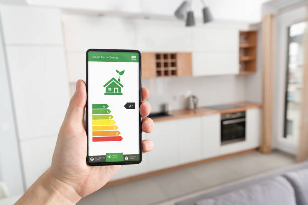 Energy efficiency mobile app on screen, eco house