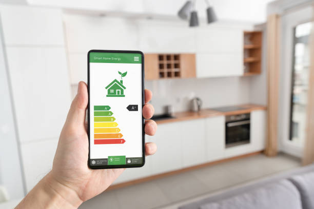 energy efficiency mobile app on screen, eco house - energy saving fotos imagens e fotografias de stock