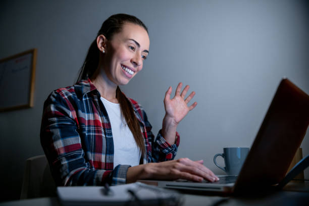 istock Woman on a video call on her computer while staying at home 1263867098