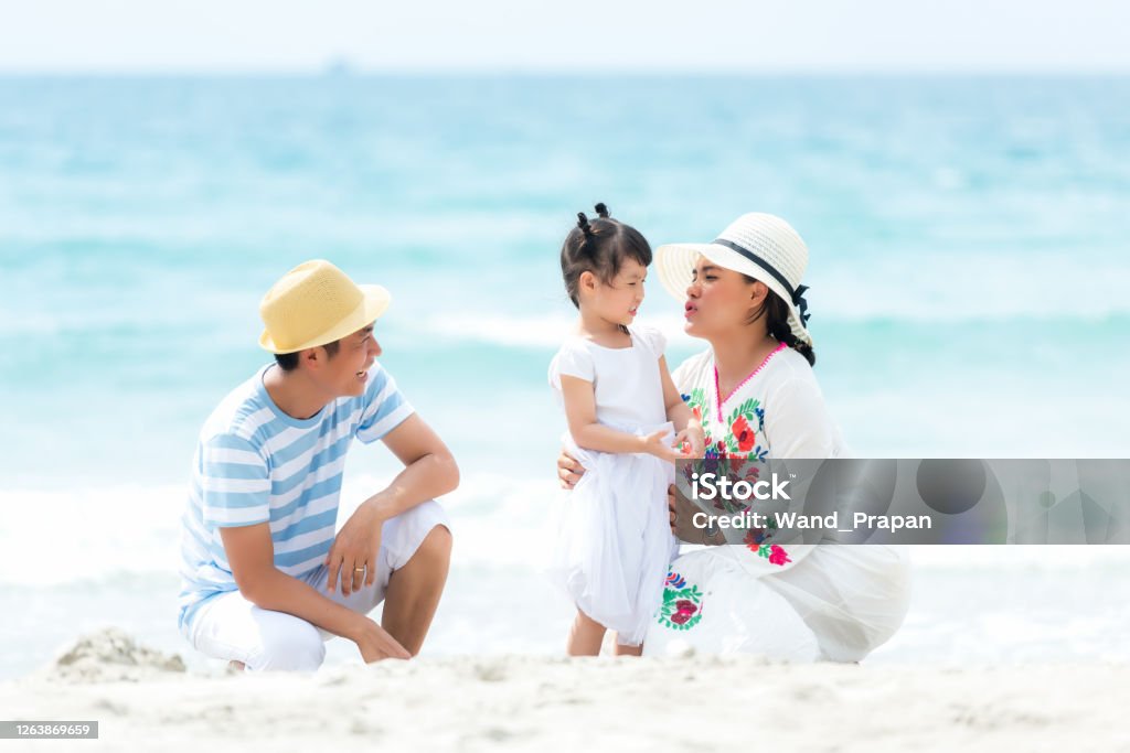 Happy family summer sea  beach vacation. Asia young people lifestyle travel enjoy fun and relax in holiday. Travel and Family Concept Active Lifestyle Stock Photo