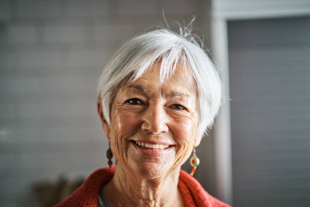 istock Senior woman standing in her kitchen at home and smiling 1263870041
