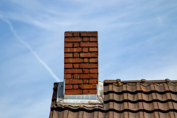istock Brick chimney on an old house roof 1263870200