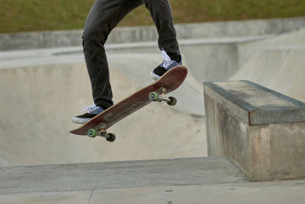 istock Asian skateboarder in action 1263873584