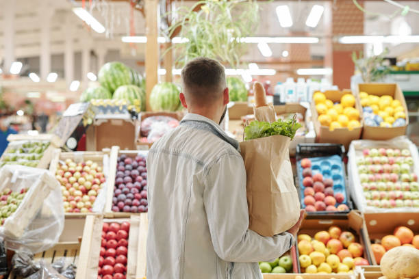 istock Man choosing juicy fruits 1263873771