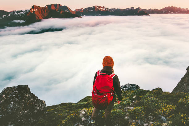 istock Adventurer backpacker on cliff over clouds in sunset mountains alone hiking adventure journey outdoor vacations traveling lifestyle weekend getaway 1263874007