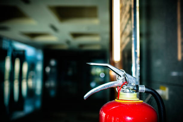 istock Close up on fire extinguisher in a modern building. The subject is on the right. 1263875698