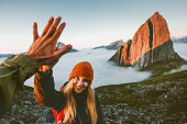 Couple friends giving five hands traveling outdoor hiking in Norway mountains adventure lifestyle positive emotions concept family together on journey vacations