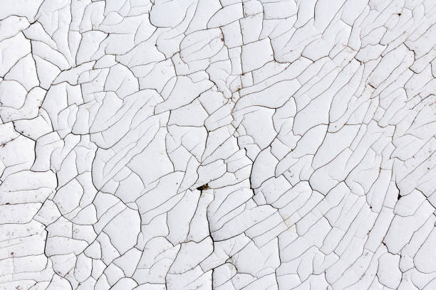 istock Chaotic cracks in an old layer of white paint 1263875747