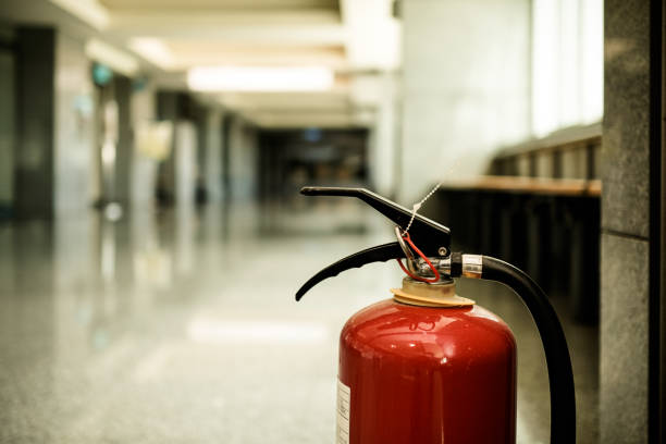 istock Close up on fire extinguisher in a modern building. The subject is on the right. 1263876343