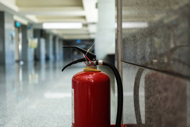 istock Close up on fire extinguisher in a modern building. There is a reflection of a fire extinguisher on the wall. 1263876367