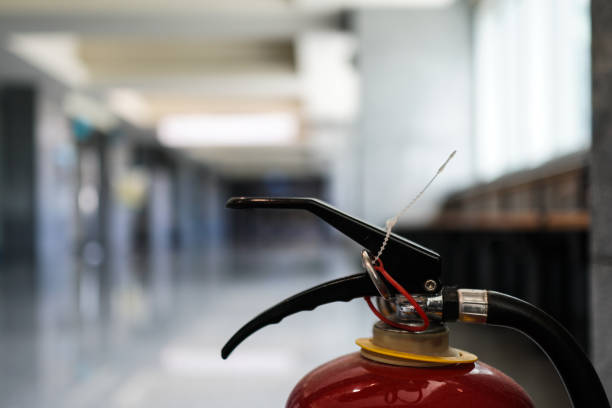 istock Close up on fire extinguisher in a modern building. The subject is on the right. 1263876374