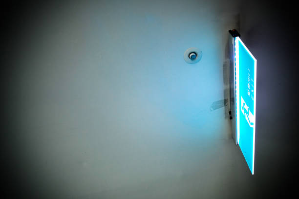 istock Emergency exit, escape route sign in a modern building. Location in public area. The Chinese characters mean emergency exits. Look up. 1263876396
