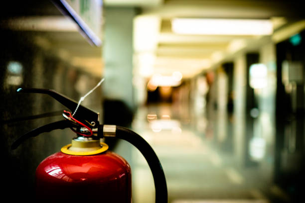istock Close up on fire extinguisher in a modern building. The subject is on the left. 1263876426