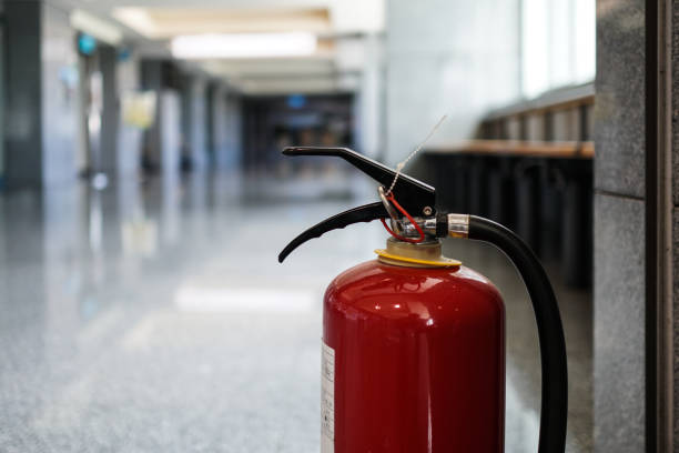 istock Close up on fire extinguisher in a modern building. The subject is on the right. 1263876554